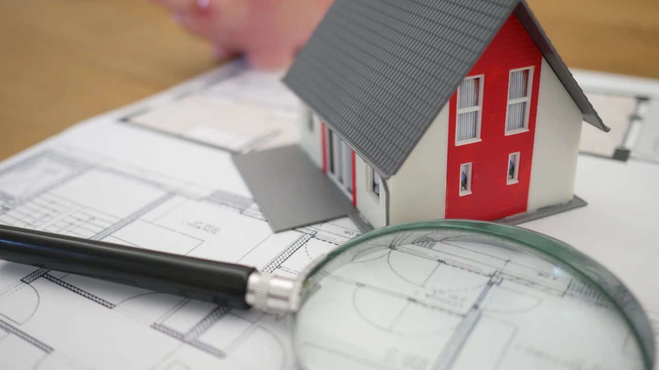 Examining property plans with a magnifying glass