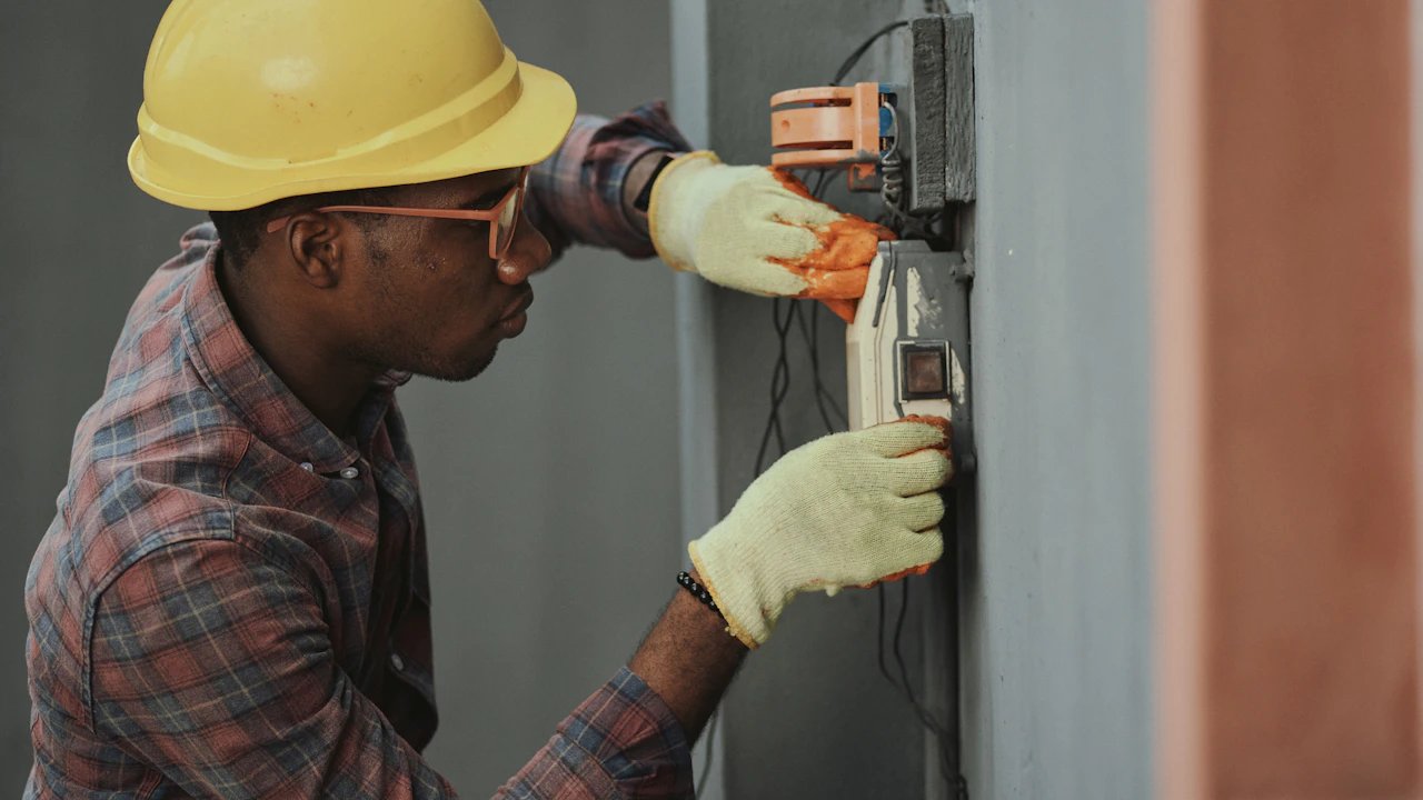 Technician performing electrical maintenance